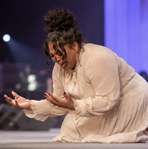 Prophet Ericka Michelle kneeling in prayer